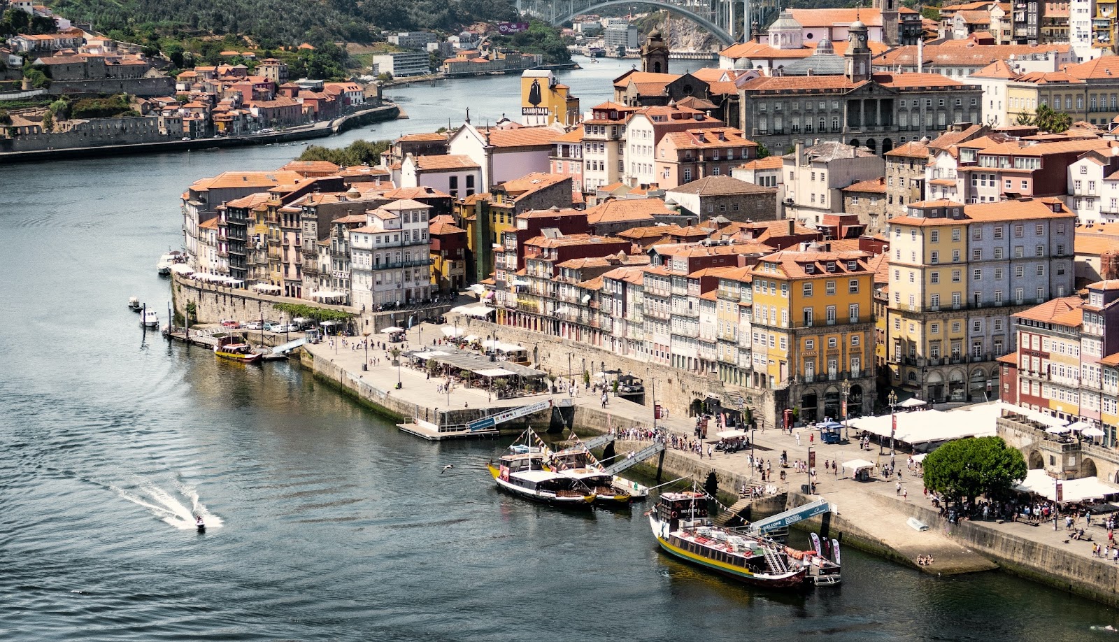 A cozy riverside village with traditional Portuguese houses nestled along the water.