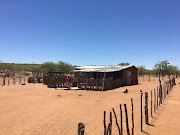 A woman outside her home in the ≠Khoadi-//Hôas conservancy, an award-winning example of how sustainable tourism can benefit the environment and local communities too. 