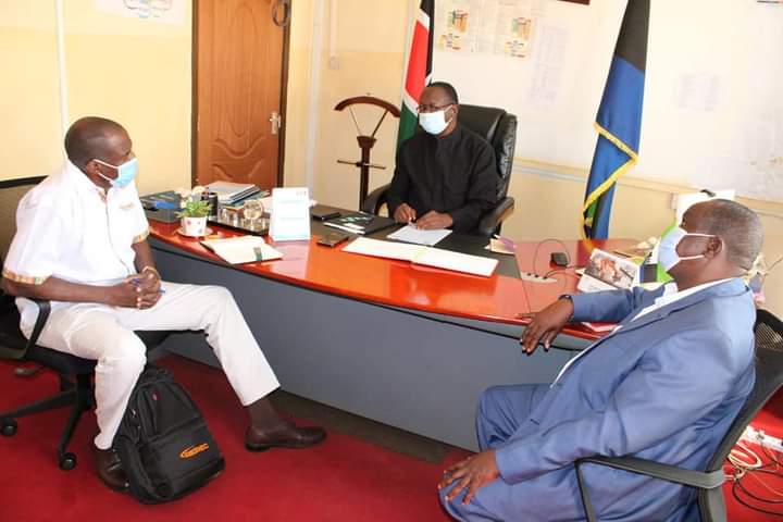 Busia Deputy Governor Moses Mulomi with REREC director Ezekiel Weya and infrastructure executive Okwara Ekirapa at his office on Tuesday