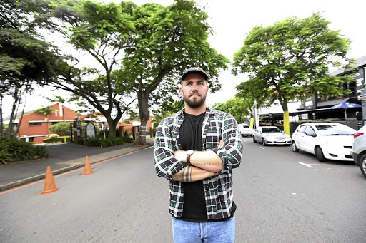 Matt Richardson of Republik in Florida Road stands in the road between his restaurant and rival establishment Dropkick Murphy's and a Catholic church.