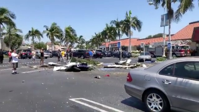 The debris of a plane which crashed into a parking lot is seen in Santa Ana, California, U.S. August 5, 2018 in this still image taken from a video obtained from social media.