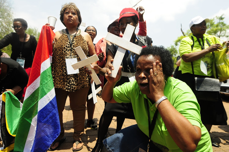 Families of mentally ill victims who died after they were moved to illegal NGO's sing outside the venue were former MEC of health in Gauteng Qedani Mahlangu gave testimony at the Life Esidimeni arbitration hearing.