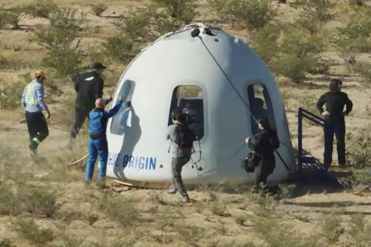 Billionaire Jeff Bezos gives a thumbs up outside the capsule of Blue Origin's New Shepard mission NS-18, which carried actor William Shatner and 3 other passengers on a suborbital flight, near Van Horn, Texas, the US, October 13 2021. Picture: BLUE ORIGIN/REUTERS