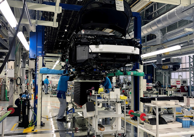 Workers install the fuel cell power system in a Toyota Mirai at a Toyota Motor factory in Toyota in Aichi prefecture, Japan. Picture: REUTERS/JOE WHITE/FILE