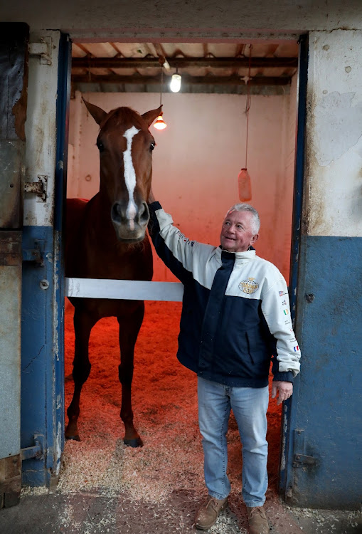 Horse trainer Michael Roberts,69, with See It Again at a stable in Summerveld Horse Training Centre.