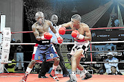 Sivenathi Nontshinga connects with a right hook en route to his ninth-round TKO of Siyabonga Siyo./ Nick Lourens