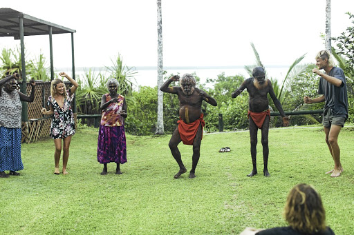 Tourists take part in a traditional dance on the Tiwi Islands, Australia.