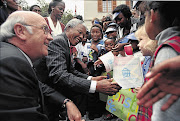 HIGH HOPES: FW de Klerk and Nelson Mandela greet children outside parliament on the day the new constitution was adopted in May 1996 Picture: