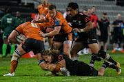 Werner Kok of the Sharks tackles Magnus Bradbury of Edinburgh in the United Rugby Championship match at Kings Park in Durban on March 26 2022.