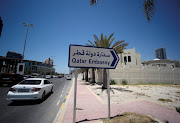 A sign indicating a route to Qatar embassy is seen in Manama, Bahrain, June 5, 2017.