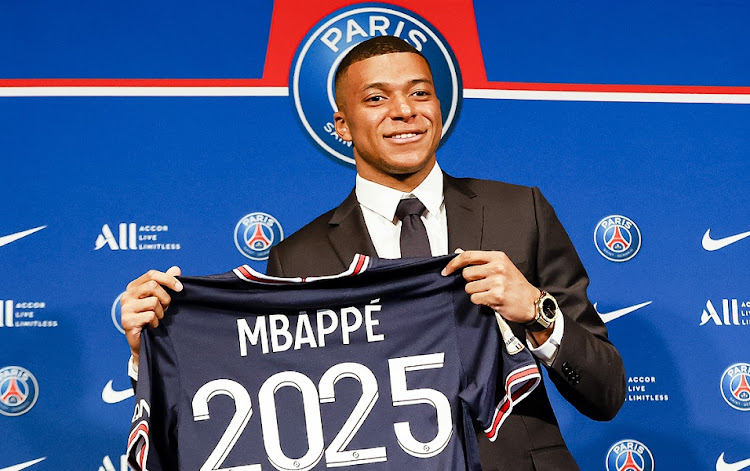 Kylian Mbappe poses with a 2025 Paris Saint-Germain t-shirt at Parc des Princes in Paris on May 23 2022 after signing his new contract.