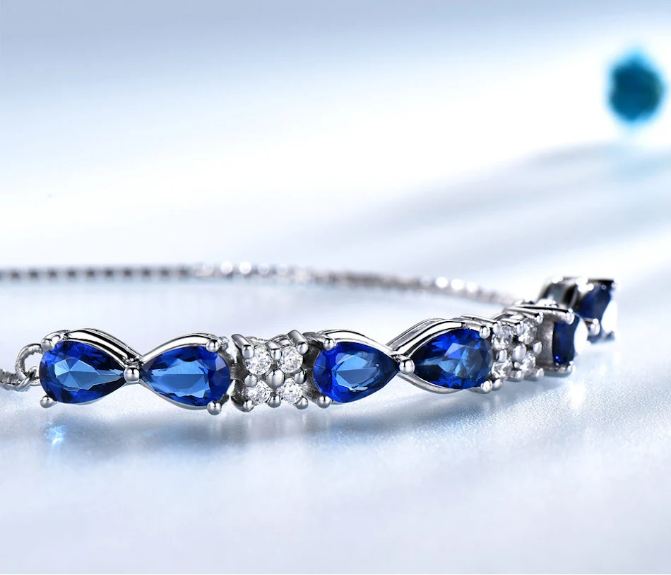 Bracciale regolabile S925 in argento sterling con zaffiro blu e catena box per donne. Un gioiello elegante e versatile per ogni occasione.