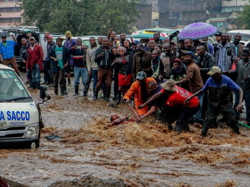 A passenger is rescued from a submerging Matatu along Grogon area Near Kirinyaga road following heavy down pour witnessed in Nairobi and its Outskirts on March 15,2018. Photo/Enos Teche.