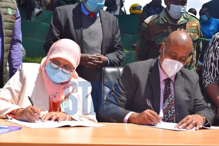 UN Habitat Kenya Executive Director Maimunah Mohd Sharif and Nairobi Metropolitan Services Director General Mohammed Badi sign an MOU on Nairobi River Regeneration at Michuki's People's Park on July 14, 2021.