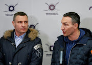 Ukrainian former heavyweight boxing world champion Wladimir Klitschko, right, who joined the Ukrainian Territorial Defence Forces, and his brother, mayor of Kyiv and former heavyweight boxing champion Vitali Klitschko, speak with journalists during the opening of the first Ukrainian Territorial Defence Forces recruitment centre in central Kyiv last month. 