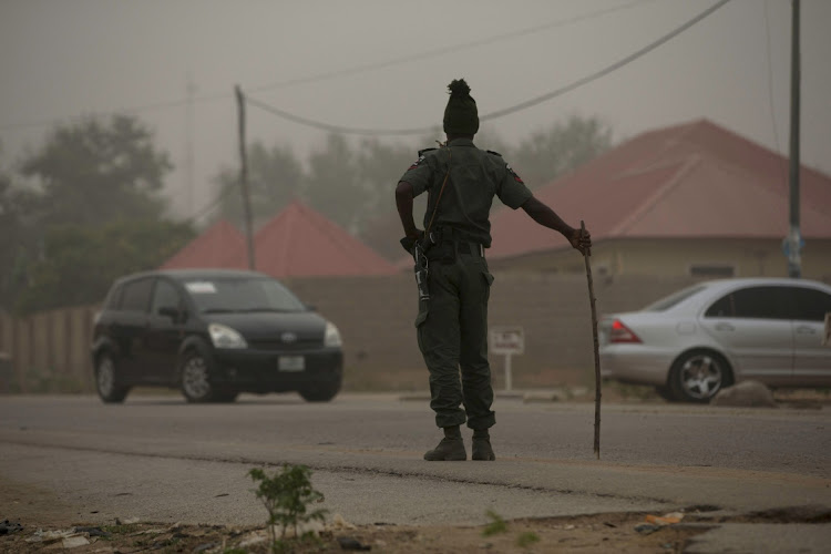 A policeman keeps watch on the road leading to Taraba state electoral commission during the announcement of the results of the Governorship and State assembly elections in Jalingo April 12, 2015.