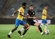 Daniel Cardoso of Kaizer Chiefs challenges Themba Zwane of Mamelodi Sundowns during the Absa Premiership match between Kaizer Chiefs and Mamelodi Sundowns at Orlando Stadium on August 27, 2020 in Johannesburg, South Africa. 