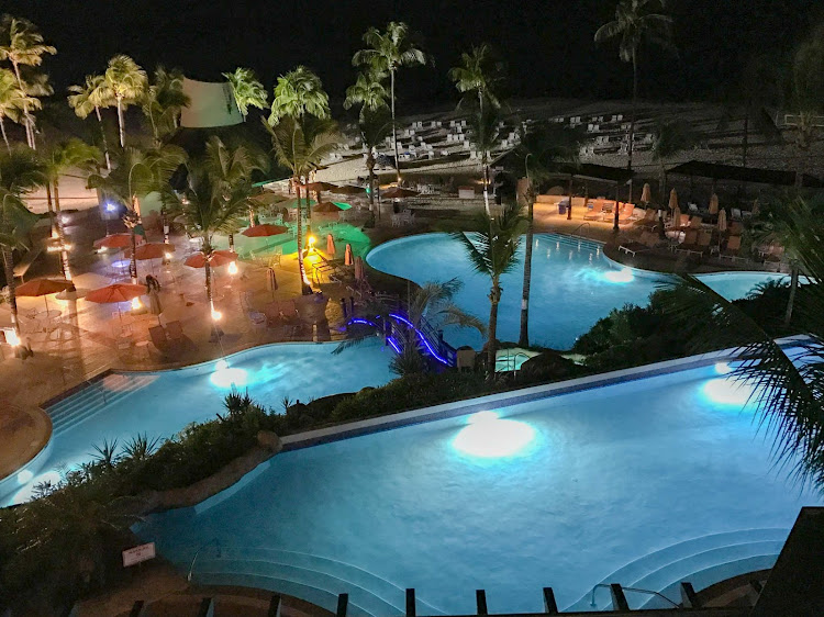 The illuminated pool of the Hilton Barbados Resort at night. 