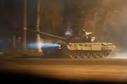 A tank drives along a street after Russian President Vladimir Putin ordered the deployment of Russian troops to two breakaway regions in eastern Ukraine following the recognition of their independence, in the separatist-controlled city of Donetsk, Ukraine, on February 22 2022.