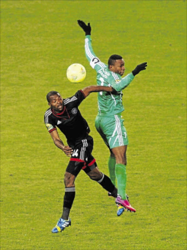 PAVING THE WAY: Rooi Mahamutsa of Orlando Pirates fights for the ball with Rudy Adey of AC Leopards during their CAF Champions League match at Orlando Stadium PHOTO: Veli Nhlapo