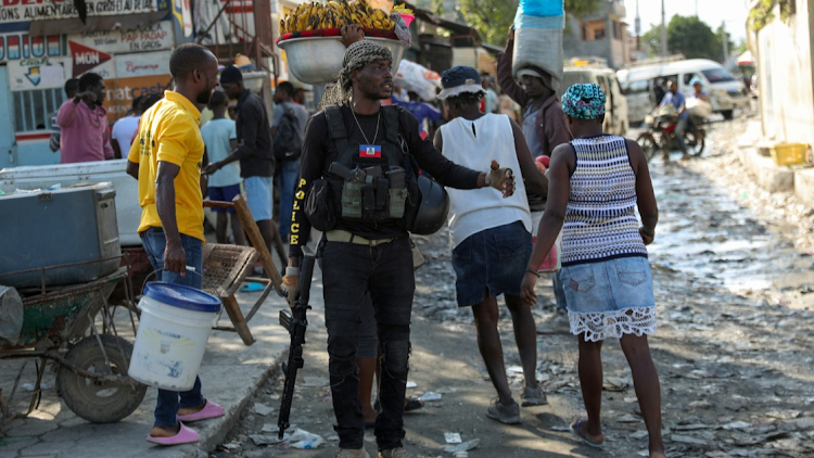 A police officer patrols near the police headquarters as Haiti continues in a state of emergency, in Port-au-Prince, Haiti March 6, 2024.