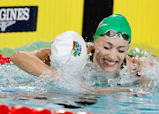 Tatjana Schoenmaker celebrates with Kaylene Corbett after they won gold and bronze in the 200m breaststroke in Birmingham. 