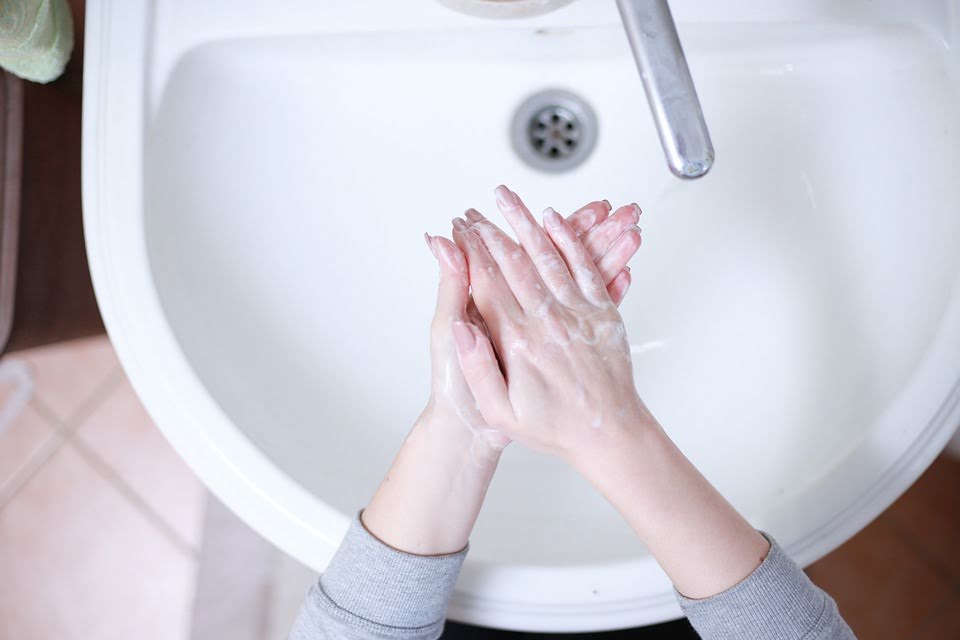 woman washing hands bathroom pixabay
