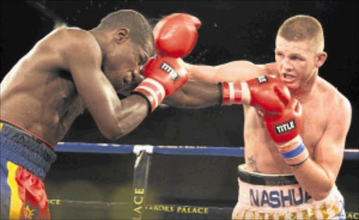 STRAIGHT RIGHT: SA's Tommy Oosthuizen forces Fulgencio Zuniga of Colombia to cover up in their battle on Saturday night at Emperors Palace. PHOTO: ANTONIO MUCHAVE