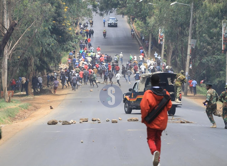 Police lob teargas to former Mungiki leader Maina Njenga's supporters on May 25.