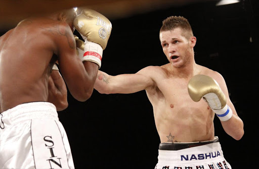 Thomas Oosthuizen lands a punch during the Super Middleweight title bout between Thomas Oosthuizen in stripes and Evert Bravo at Emperor's Palace March 26, 2011 in Johannesburg