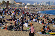 People spend time at Barceloneta beach, amid the coronavirus disease (Covid-19) outbreak, in Barcelona, Spain on April 2, 2021. 