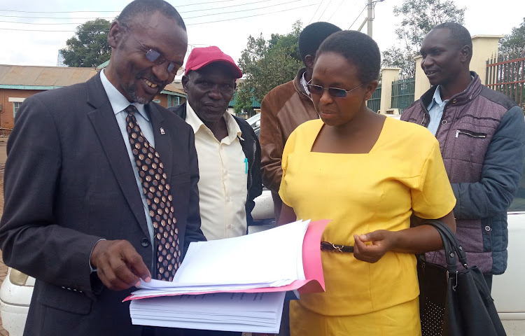 Lawyer Eliud Miyienda talks with parents of the students at the High Court in Eldoret