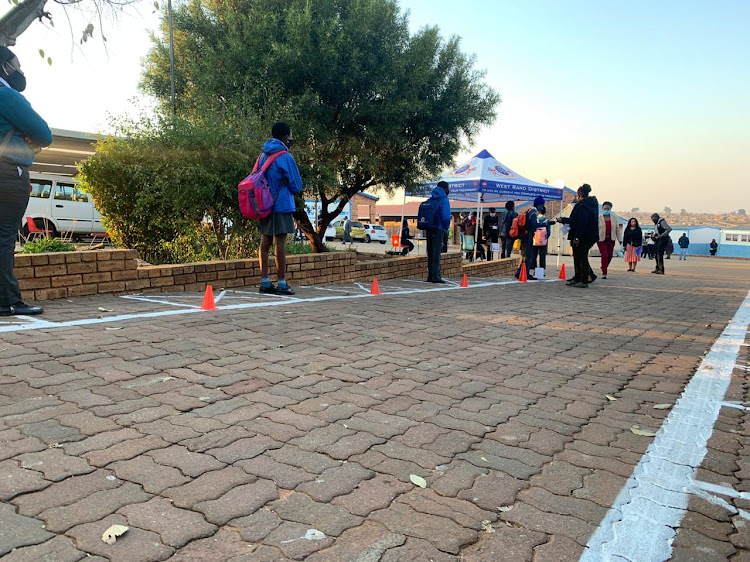 Learners from Tsakani Primary School in Kagiso on the West Rand are being screened before entering the school.