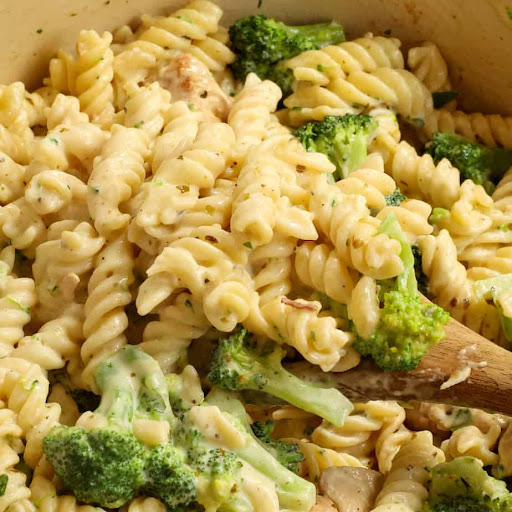 A delicious and easy Chicken Broccoli Alfredo pasta dish with golden brown chicken bites, crisp tender broccoli, rotini pasta, and homemade alfredo sauce.