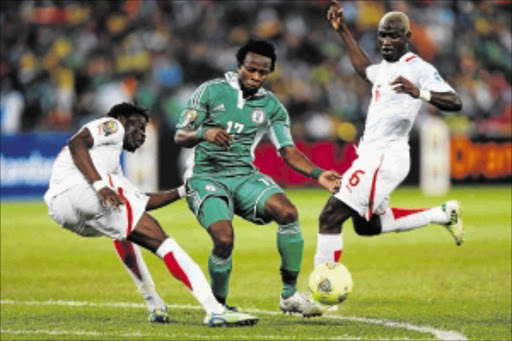 ROADBLOCK: Nigeria's Ogenyi Onazi is tackled by Burkina Faso's Djakaridja Kone during the 2013 Africa Cup of Nations final at FNB Stadium in Johannesburg. The Super Eagles will play Bafana Bafana in the annual Nelson Mandela Challenge next month. Photo: Getty Images