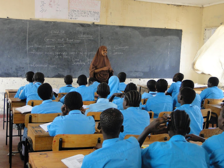 Volunteer teacher Anisa Mohammed teaches Form 1 students English. Her class has more than 60 learners