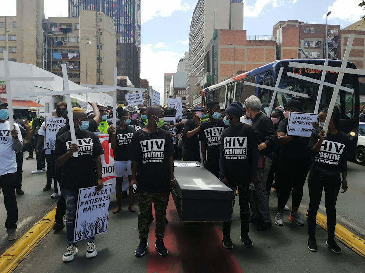 A coffin carried by marchers symbolised the patients who lost their lives while waiting for treatment.