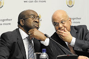 A WORD IN YOUR EAR: New Finance Minister Nhlanhla Nene, left, and predecessor Pravin Gordhan. Nene is known to agree with the former minister's macroeconomic philosophy