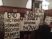 Protesters from the group Reclaim the City, who oppose the sale of state land to private developer in Cape Town, picketed Western Cape Premier Helen Zille's delivery of the Colin Eglin Memorial Lecture at the Cape Town Club on Thursday night. Zille continued and finished her speech.