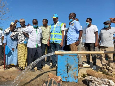 Kenya Development Response to displacement Impacts project coordinator Farah Mohamed (right) inspects a water project in Nanigi ward August 20.