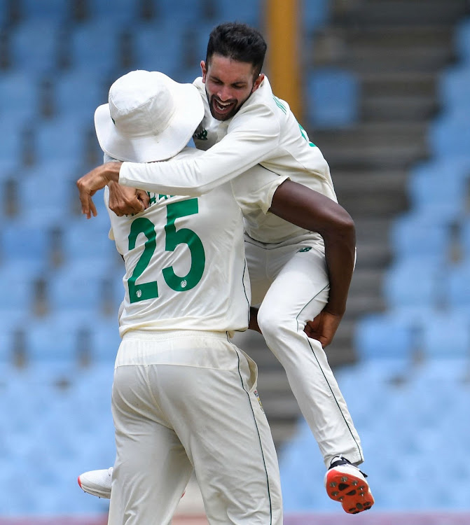 Keshav Maharaj celebrates his hat-trick with Kagiso Rabada