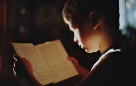Boy reading book small promo image