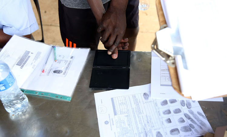 A potential recruit has his fingerprints taken before starting the fitness test at Modderbee Correctional Services, Benoni.