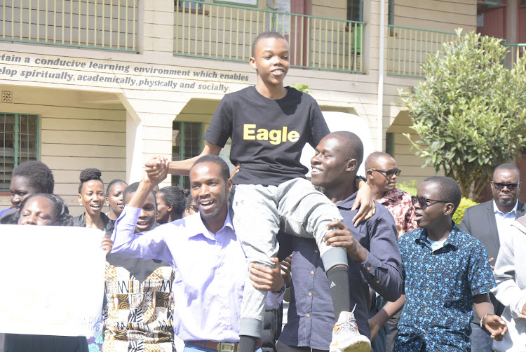 Parents and teachers of New Bambini School in Thika celebrate with the fourth top candidate in the country Emmanuel Kaberia who scored 425 marks.