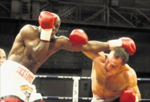 Dejan Zaveck lands a right hook on Isaac Hlatshwayo. Pic. Bafana Mahlangu. 13/12/2009. © Sowetan.