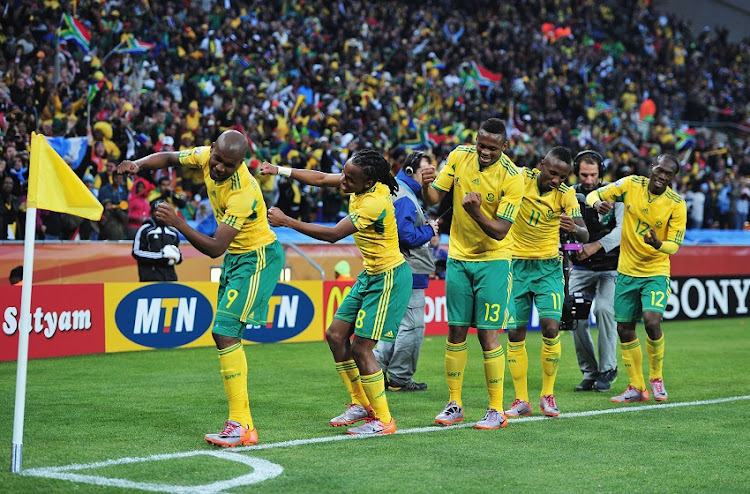 Siphiwe Tshabalala (C) of South Africa celebrates scoring the first goal with team mates during the 2010 FIFA World Cup South Africa Group A match between South Africa and Mexico at Soccer City Stadium on June 11, 2010 in Johannesburg, South Africa.