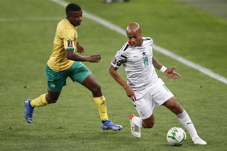 Ghana's Andre Ayew (R) fights for the ball with South Africa's Teboho Mokoena (L) during a FIFA World Cup Qatar 2022 qualifier at the FNB Stadium in Johannesburg on September 6