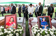 Tanzanian Prime Minister Kassim Majaliwa stands in front of the coffins as he pays homage to the victims following the crash of the Precision Air ATR 42-500 passenger plane into Lake Victoria, at the Kaitaba Stadium in Bukoba, Tanzania on November 7, 2022.