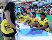 Jozi Stars players sign autographs after a match in Johannesburg. 