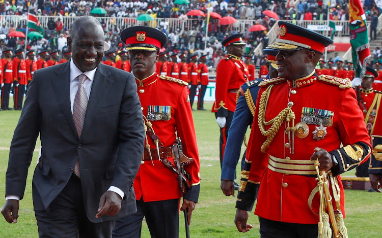 Kenya's President William Ruto is escorted by Robert Kibochi, chief of Kenya defence forces, during the country's 59th Independence Day celebrations, at Nyayo National Stadium in Nairobi, Kenya, December 12 2022. Picture: MONICAH MWANGI/REUTERS